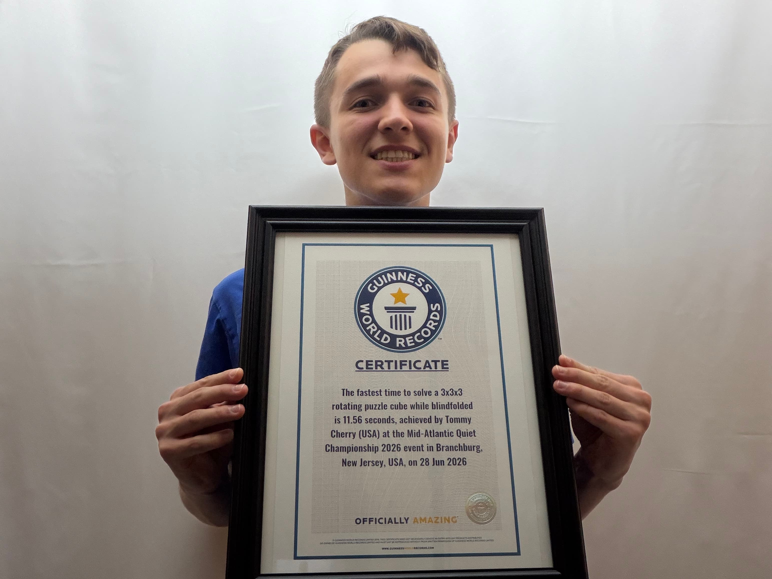 Tommy Cherry holding his Guinness World Records certificate